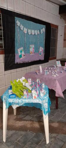 a table with a blue table cloth and toys on it at Casa Imponente Vila Atlântica - Beira Mar in Mongaguá