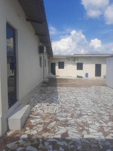 a building with a stone walkway in front of a building at Apart Hotel M6D in Rio Branco