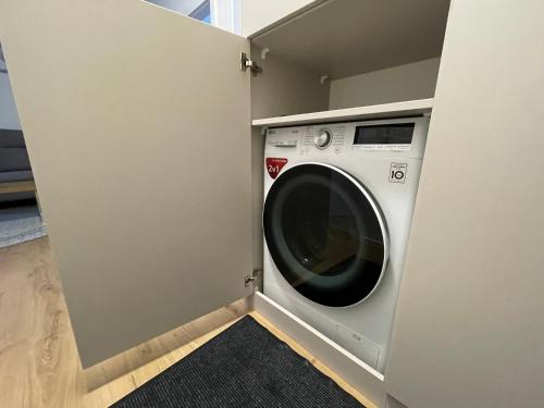 a washer and dryer in a small room at Apartmán Holia, Kubínska Hoľa in Dolný Kubín