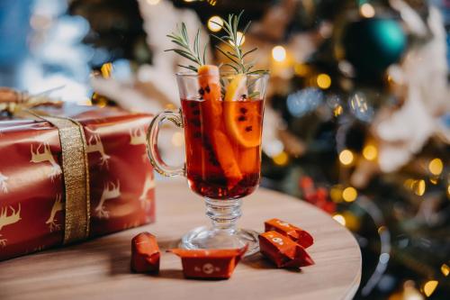 a glass cup with carrots in it next to a christmas tree at Five Seasons Szklarska Poręba in Szklarska Poręba