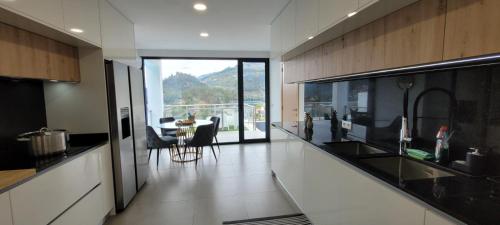 a kitchen with a view of a table with chairs at Geresmarinahouse in Geres