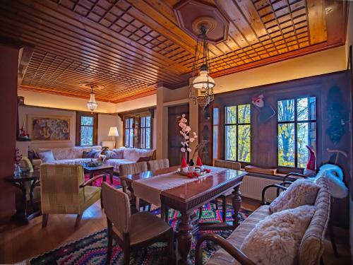 a living room with a table and chairs at KP113 All Season Villa in Makrinitsa in Makrinítsa