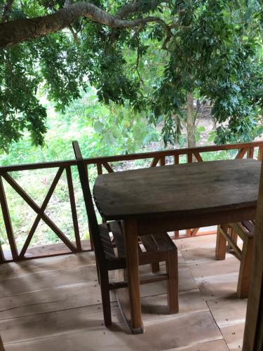 a wooden bench sitting on top of a deck at Gaga addara resort in Habarana