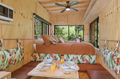 a bedroom in a tree house with a bed and a table at Holiday with Nature in Cooran