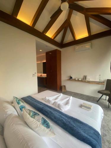 a bedroom with a white bed and a couch at Amila Dive Beach Resort in Sipalay