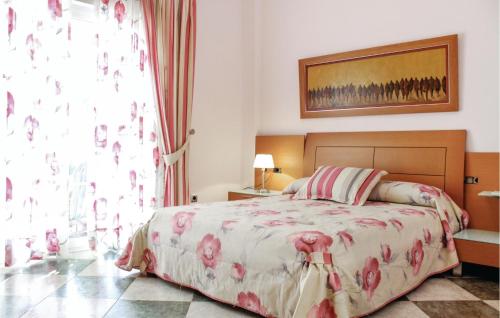 a bedroom with a bed and a large window at Pet Friendly Home In Playa Honda in Playa Honda