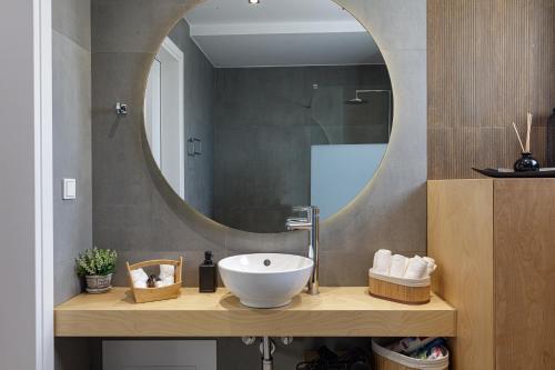 a bathroom with a sink and a mirror at EVELAND ACCESSIBLE VILLAS in Sfakaki