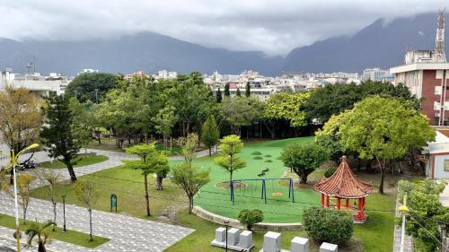 a park with a playground in a city at Rhino Guest House in Hualien City