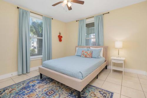 a bedroom with a bed and two windows at Cordova Dream Manor in St. Augustine