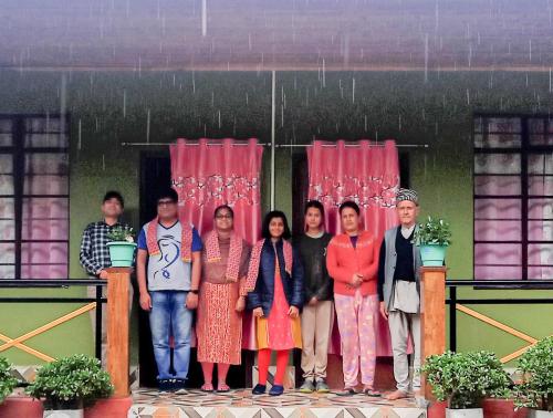 a group of people standing on a stage at 3 Sisters' Homestay in Ravangla