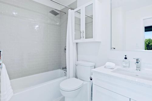 a white bathroom with a toilet and a sink at Bellingham Home Away from Home in Bellingham