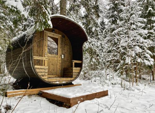 a wooden cabin with a door in the snow at Ennu’s hut in Loksa