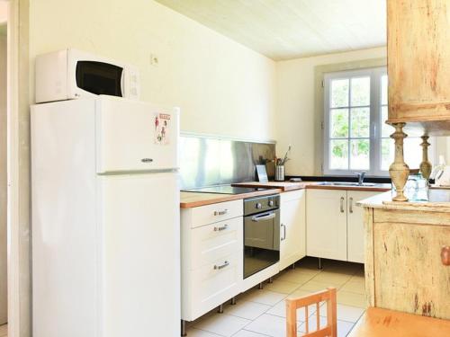 a kitchen with white appliances and a white refrigerator at Maison Les Portes-en-Ré, 3 pièces, 4 personnes - FR-1-434-73 in Les Portes