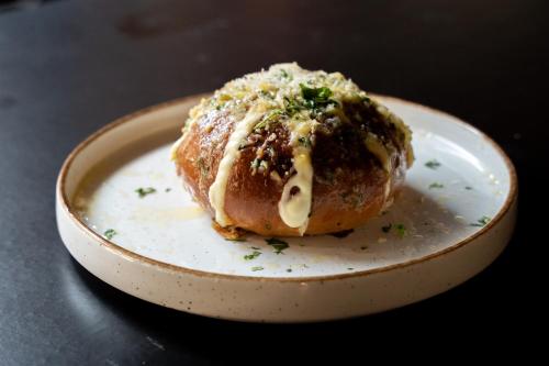a pastry on a plate on a table at Sawantwadi Palace Boutique Art Hotel in Sawantwadi