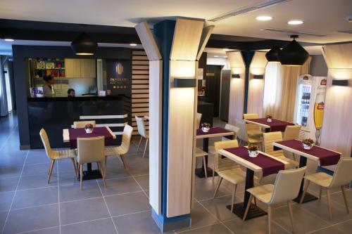 a restaurant with tables and chairs in a room at Panorama Business Inn in Cluj-Napoca