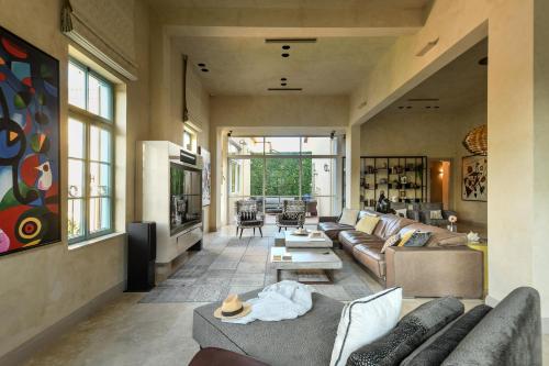 a living room with a couch and a table at The Pearl of Jaffa Lux Apartment by Sea N' Rent in Tel Aviv