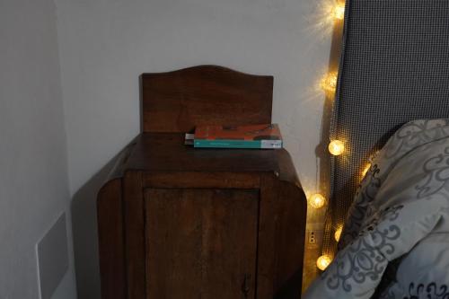 a wooden table with a box on it next to a mirror at MIMAR Casa Vacanze Charme ed Eleganza in Maruggio