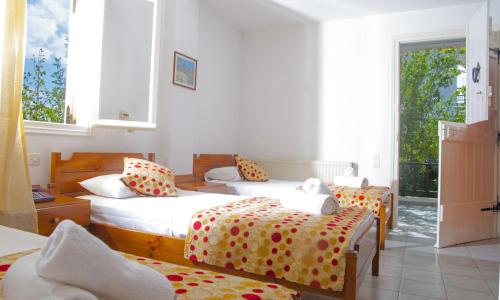a bedroom with three beds with polka dot sheets at Villa Medusa in Hersonissos