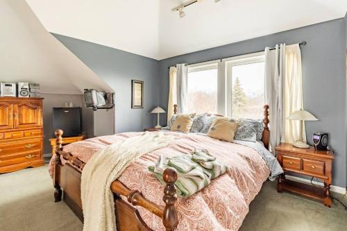 a bedroom with a large bed and a window at Ye Olde Walkerville Bed & Breakfast in Windsor