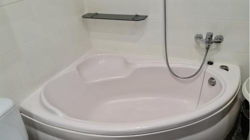 a white bathroom with a toilet and a shower at Spokojny Wypoczynek 4 in Ostrów Wielkopolski