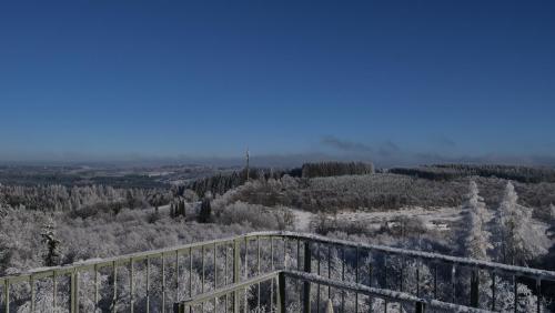 a view of a snow covered hill with a fence at Ferienhaus Broche in Hilchenbach