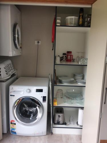 a washer and dryer in a small kitchen at Acheron Cottages in Manapouri