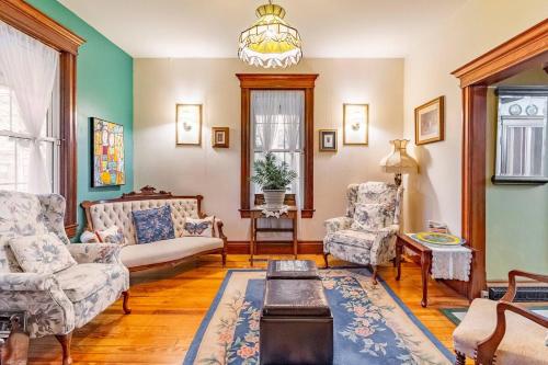 a living room with a couch and two chairs at Ye Olde Walkerville Bed & Breakfast in Windsor