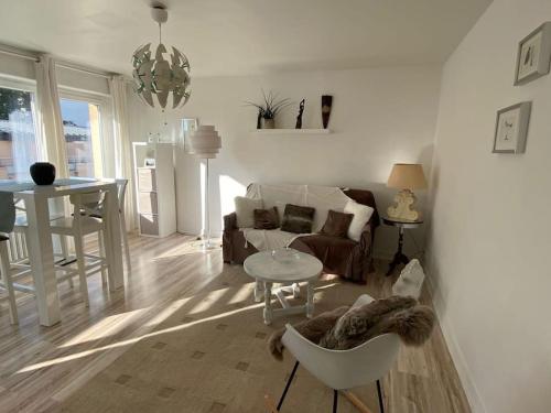 ein Wohnzimmer mit einem Sofa und einem Tisch in der Unterkunft Hirondelle : Appartement privé avec garage in Annecy