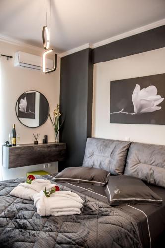 a bedroom with a bed with towels on it at Escape Luxury Apartment in Nafplio