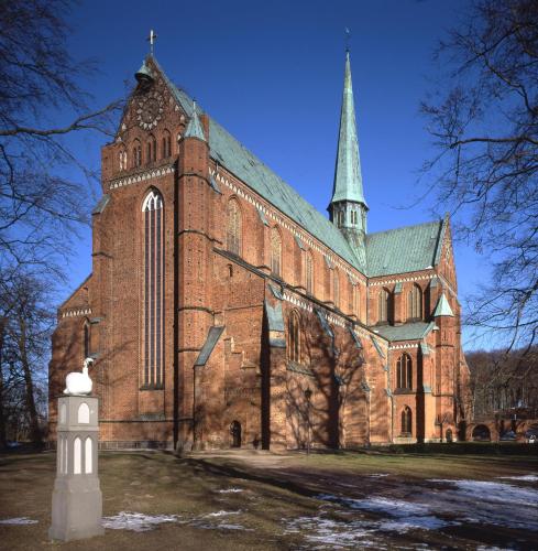 a large brick church with a steeple on top of it at Hotel Prinzenpalais Bad Doberan in Bad Doberan