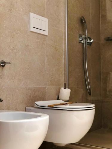 a bathroom with a toilet and a sink at Hotel Saraceno Al Faro in Taranto
