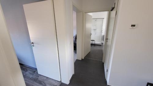 a hallway with two white doors and a room at Ferienwohnung-Irxleben in Irxleben