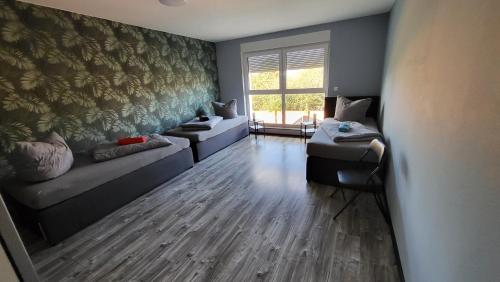 a living room with two couches and a window at Ferienwohnung-Irxleben in Irxleben