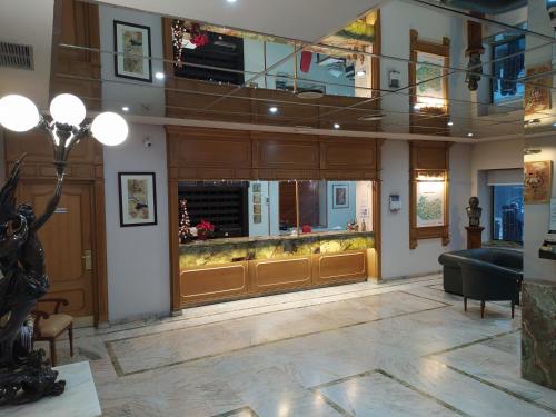 a lobby with a large window and a couch at Hotel Santa Cecilia in Ciudad Real