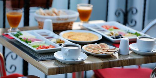 a table topped with plates of food and drinks at Grand Niki Hotel & Spa in Antalya