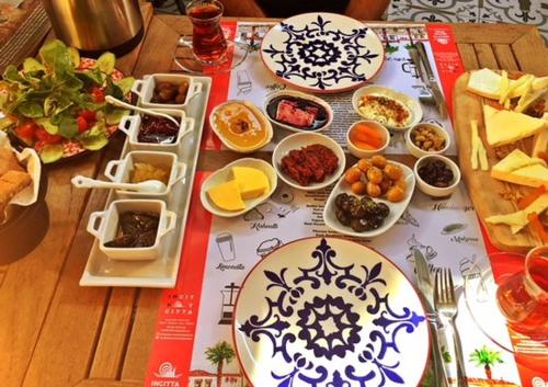 a table with plates and bowls of food on it at Grand Niki Hotel & Spa in Antalya