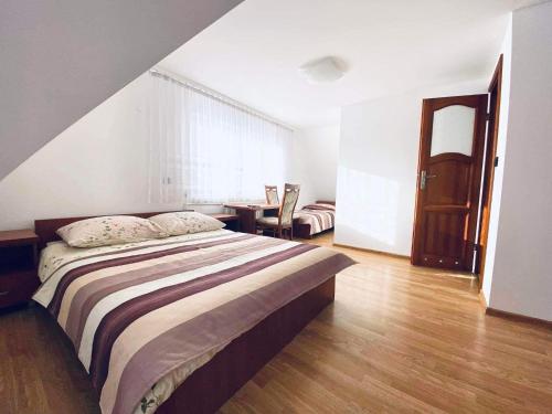 een slaapkamer met een groot bed en een tafel bij Pokoje Gościnne Letycja in Biały Dunajec