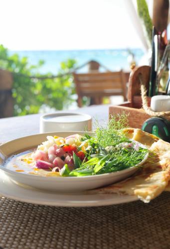 a plate of food sitting on a table at Aya Beach Resort in Kizimkazi