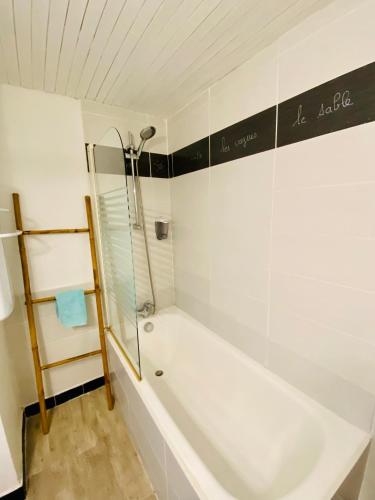 une salle de bain avec une baignoire blanche et une douche dans l'établissement Appartement N°8 Vue Mer, Perros Guirec, à Perros-Guirec