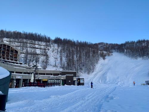 a snow covered ski slope with a ski lodge at Cervinia Ski In Ski Out - Studio with Terrace in Breuil-Cervinia