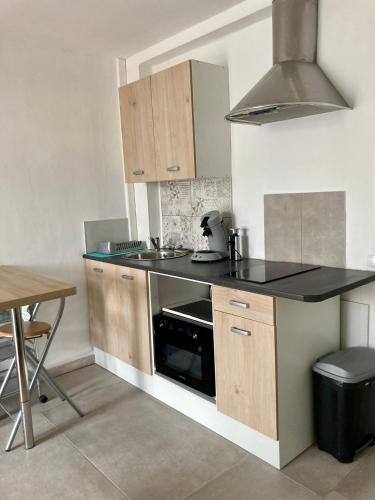 une cuisine avec un évier et une cuisinière four supérieur dans l'établissement Studio tout confort bien situé, à Orléans