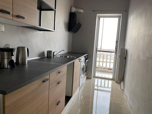 a kitchen with a sink and a washing machine at Elegant City Flat in Athens