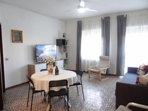 a living room with a table and a couch at Roberta's House, a few steps from the lake in Bellano
