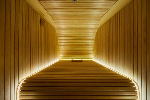a sauna with a bench in the middle of a tunnel at Boutique Sauna ARCH in Tokyo