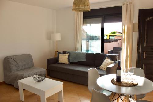 a living room with a couch and a table at La Casinha in Lajares