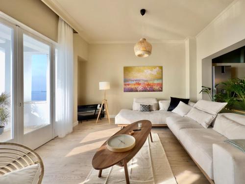 a living room with a couch and a table at #Infinity & Beyond seafront apts, amazing view in Thessaloniki