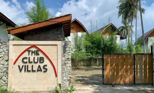 a sign that reads the club villas next to a gate at The Club Villas Lombok in Sekotong