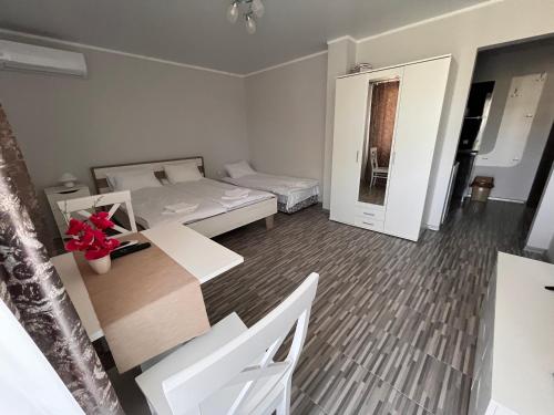 a small room with two beds and a table at Studio SeaDream in Primorsko