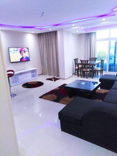 a living room with a couch and a table at Andalusia Blue Beach Hurghada in Hurghada