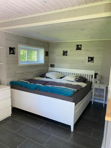 a bedroom with a large bed in a room at Spjutås Gård in Öxabäck